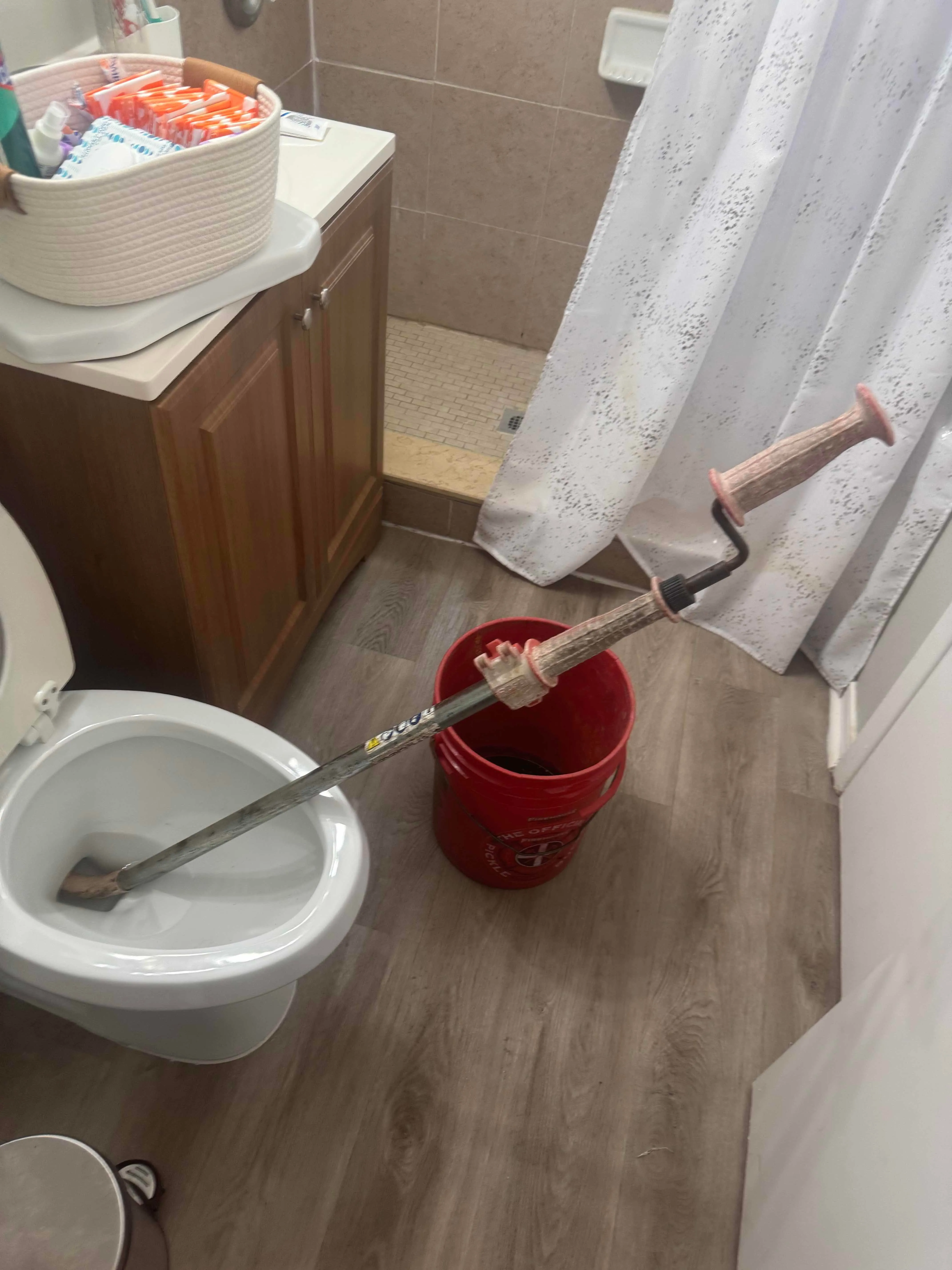 Doctors Inlet plumber clearing a clogged toilet — R Stud Plumbing