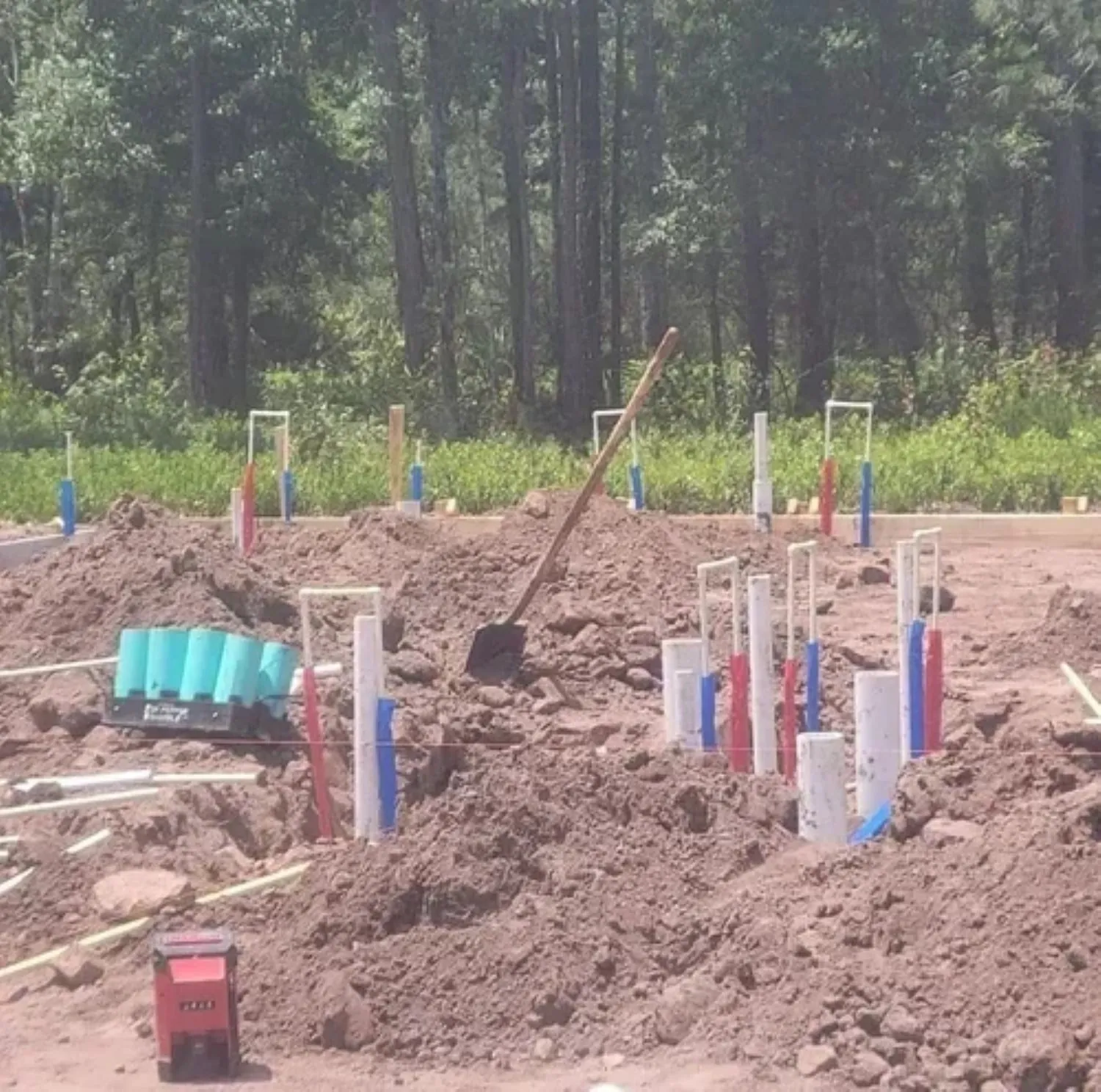 Plumbing contractor installing supply and drain lines on a new construction project