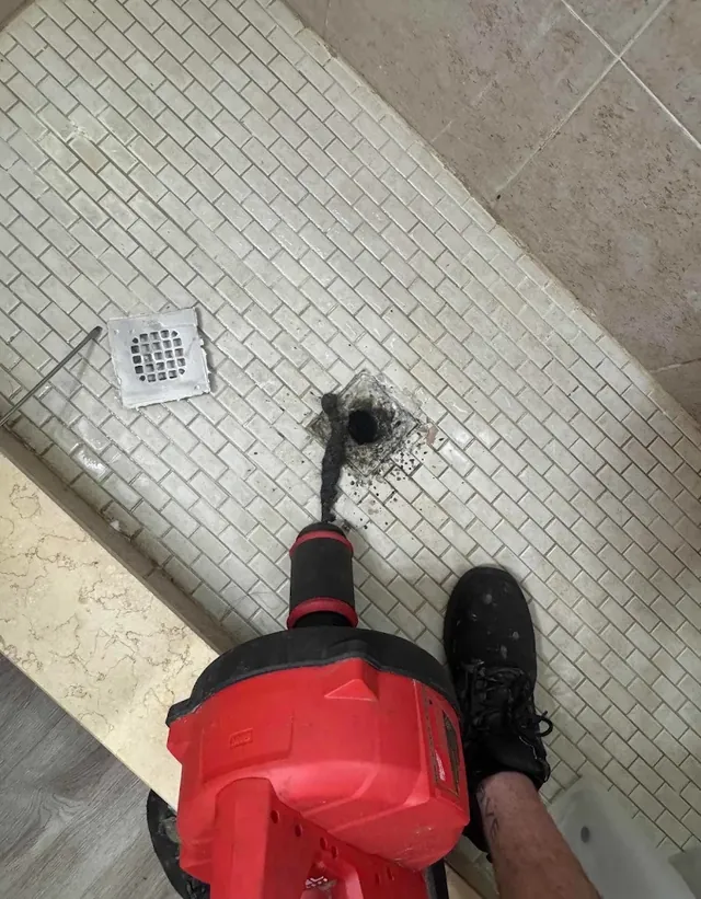 Residential shower drain cleaning with power snake