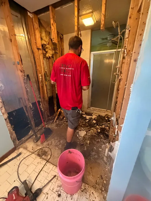 Shower remodel demolition with plumbing exposed