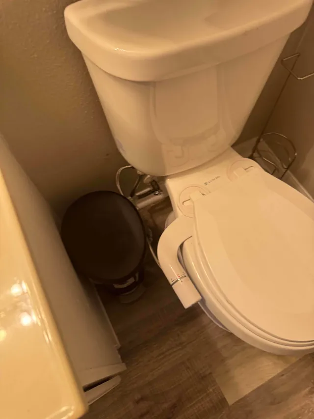 Toilet with bidet attachment installed