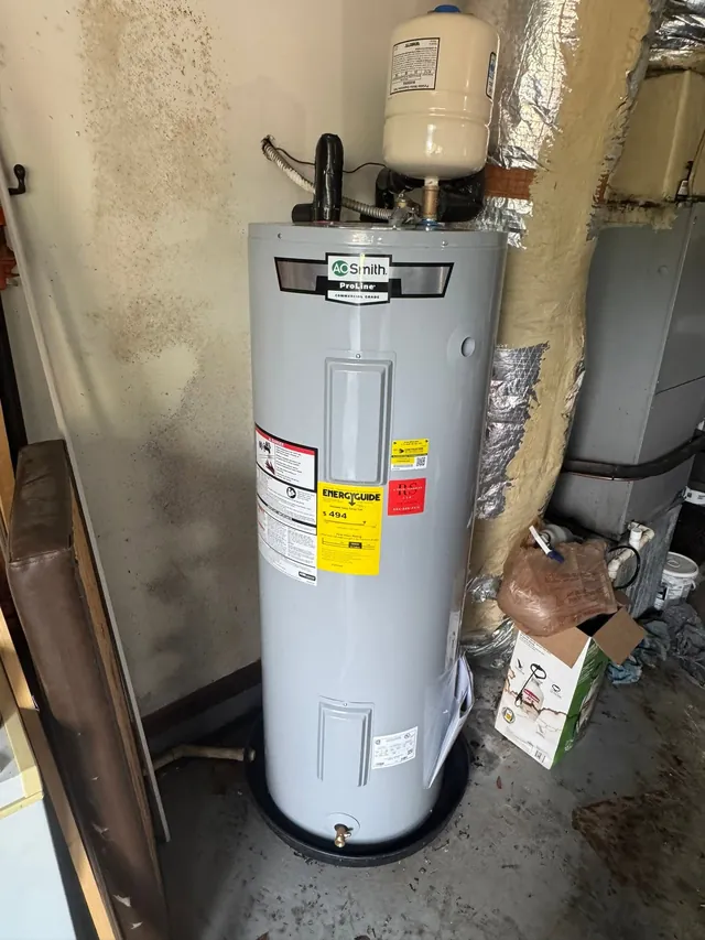 Licensed plumber servicing a water heater